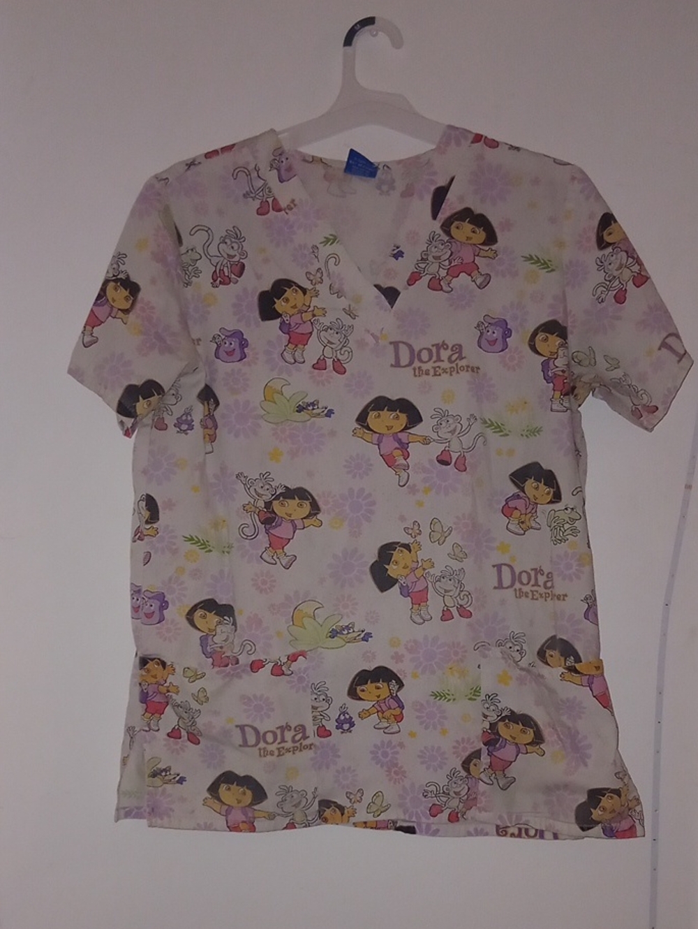 Nickelodeon Dora the Explorer V-neck scrub top featuring an allover cartoon 2002